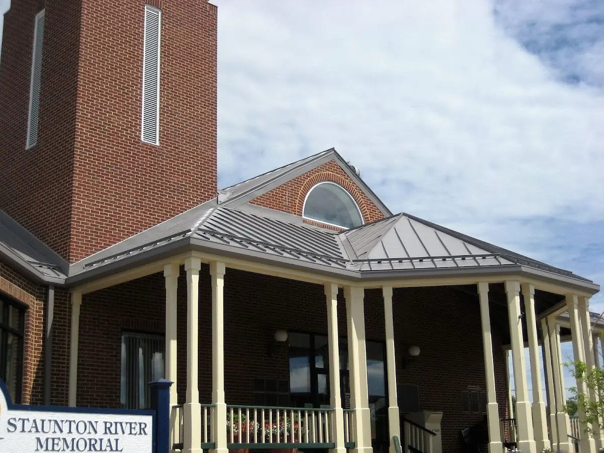 Skilled roofing craftsmen working on a residential roof in Candia